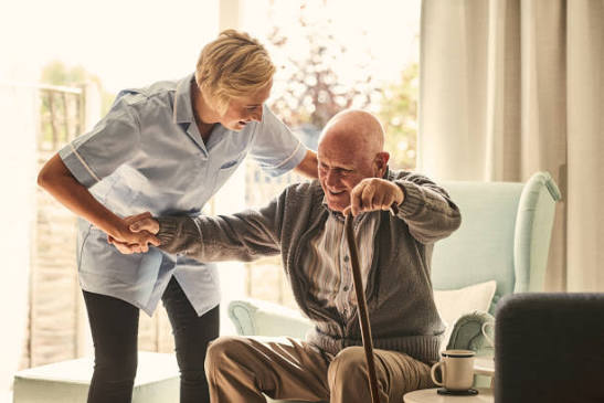 Carer helping a client at home